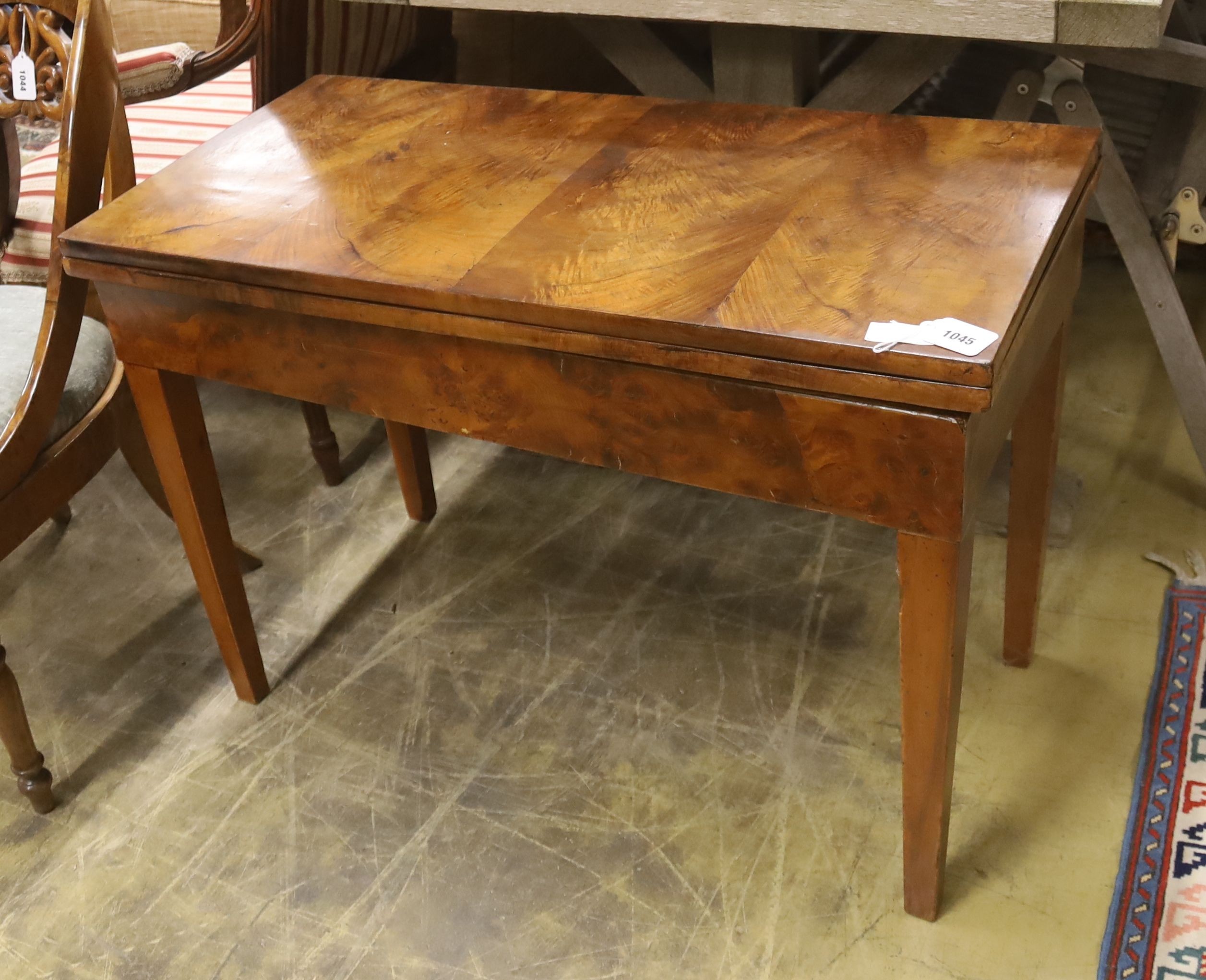 A 19th century Continental walnut rectangular tea table with folding top, (cut down), width 89cm, dpeth 44cm, height 63cm